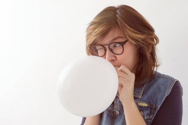 Girl inflates a balloon  clipart