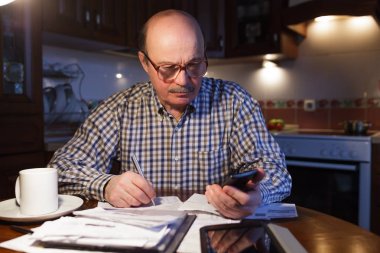 A man tiredly considers the family budget clipart
