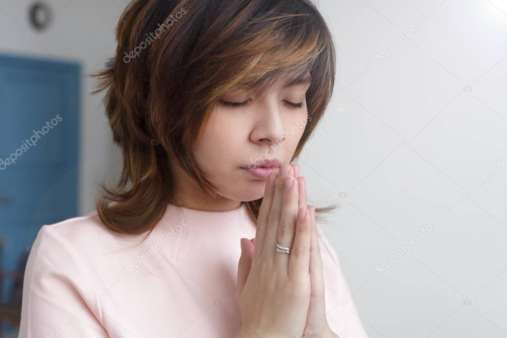 Asian girl praying to God