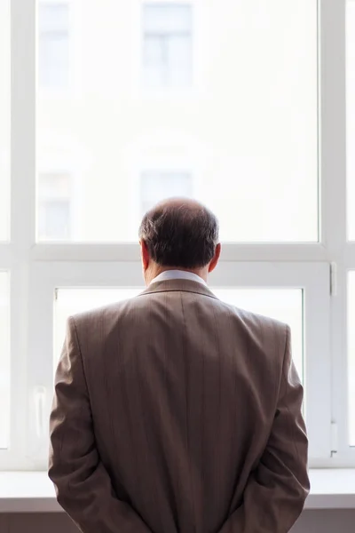 Retrato de um homem de terno junto à janela . — Fotografia de Stock