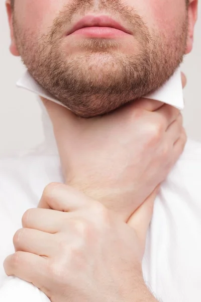 A young man being strangled or choking over white. — Stock Photo, Image