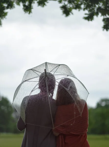 Two women walking park in rain and talk. Friendship and people communication. Rainy — Stock Photo, Image