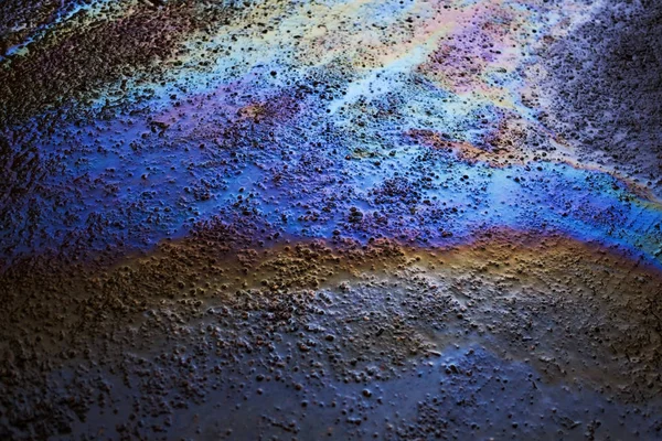 Background texture of an oil spill on road — Stock Photo, Image