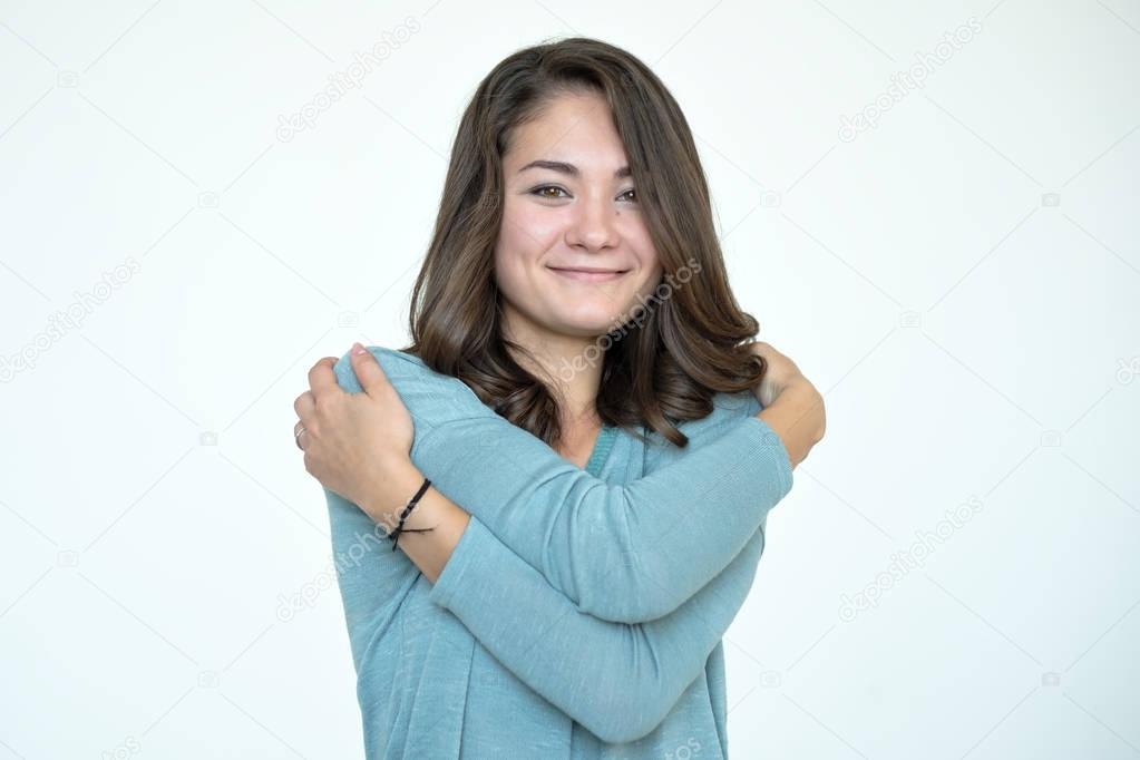 Happy caucasian woman hugging herself 