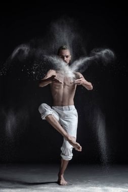 Yoga ya da pilates egzersiz yaparak beyaz spor pantolon giyen beyaz genç adam portresi.