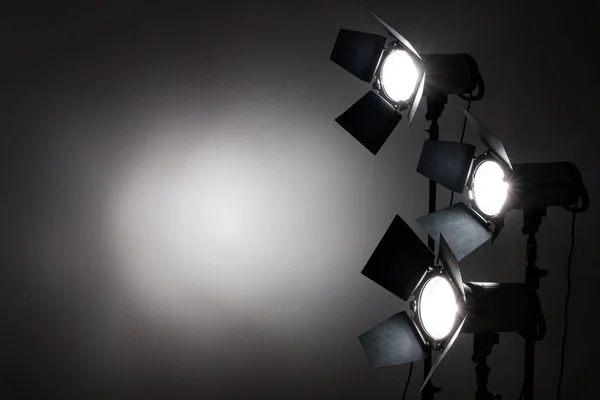 Several reflectors on the black background in photo studio. — Stock Photo, Image