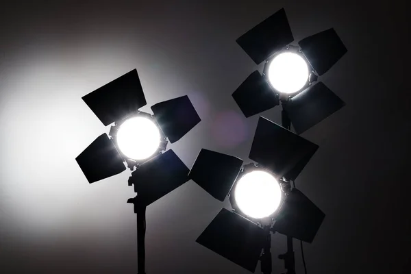 Several reflectors on the black background in photo studio. — Stock Photo, Image