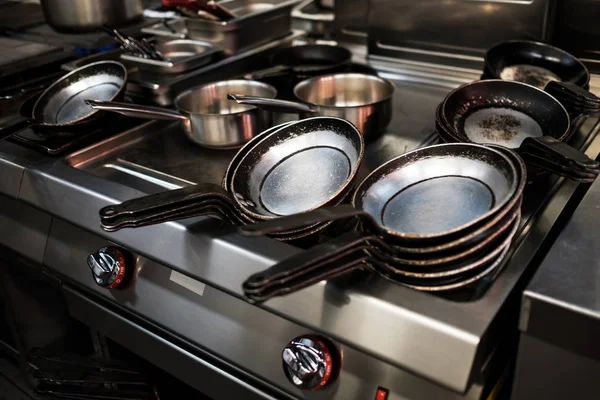 Metal black pans on restaurant kitchen — Stock Photo, Image