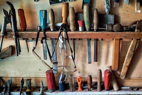 木墙上挂着凿子、铁锤和其他工具 — 图库照片
