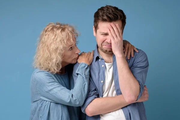 supporting woman consoling and comforting sad worried man