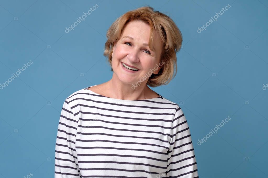 Elderly lady with a lively smile looking directly at the camera