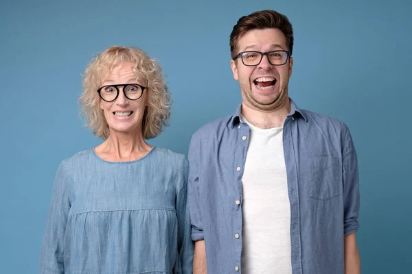 Positive coworkers with funny happy expressions, show white teeth, smile broadly — Stock Photo, Image