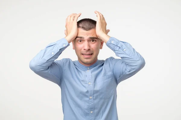 Stressiger junger hispanischer Mann in blauem Hemd. Zerstörerisches Verhalten. — Stockfoto