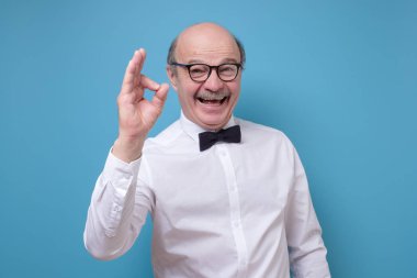 Satisfied positive hispanic man gesturing Ok sign approving your choice.