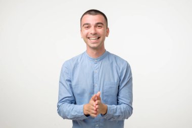 Happy hispanic casual man smiling in blue shirt. Positive facial human emotion