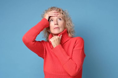 Stresli yaşlı mutsuz kadın. Kronik baş ağrısı çekiyor.