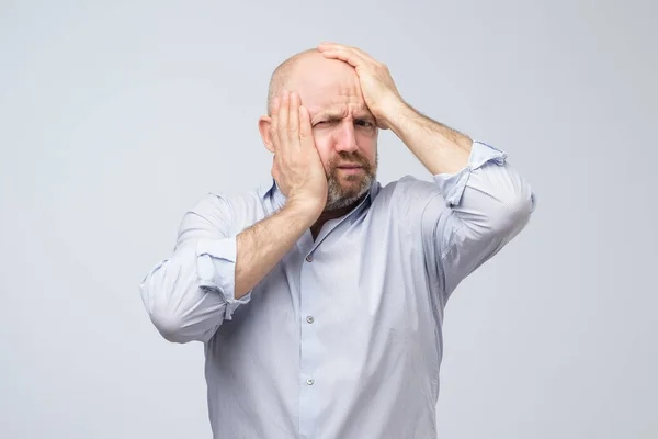 Mature caucasian man having headache feeling tired after hard day. — Stock Photo, Image