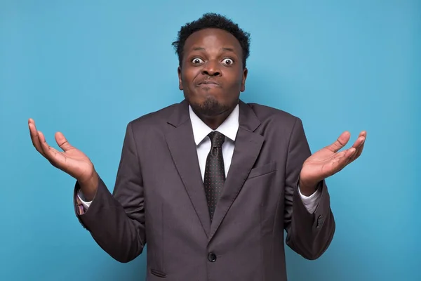 African american businessman in suit looking doubtful having no answer or clue. — Stock Photo, Image