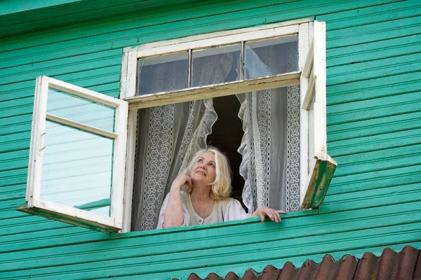 Senior Caucasian Woman Grandmother Standing Window Looking Outdoor Green Wooden — Stock Photo, Image