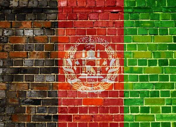 Bandera de Afganistán sobre un fondo de pared de ladrillo — Foto de Stock