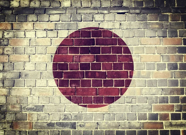 Grunge bandeira do Japão em uma parede de tijolo — Fotografia de Stock