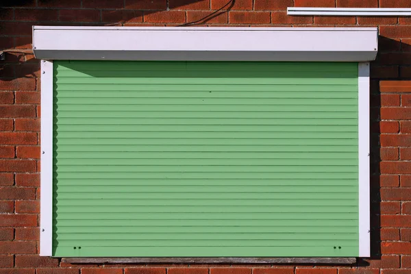 Closed green security shutters — Stock Photo, Image