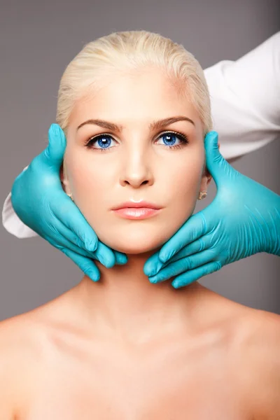 Cosmetic plastic surgeon touching aesthetics face — Stockfoto