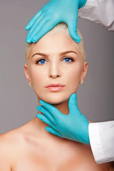 Cosmetic plastic surgeon touching aesthetics face — Stockfoto