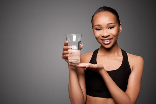 Happy healthy black asian woman with water — Stock Photo, Image