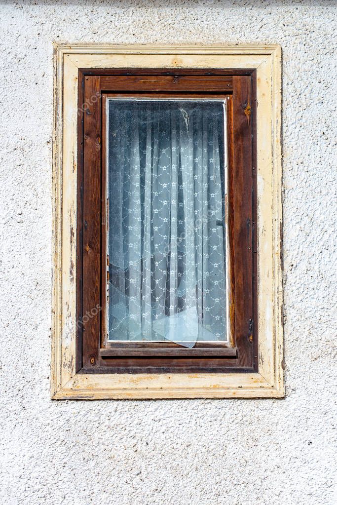 Destroyed window pane in a wood window