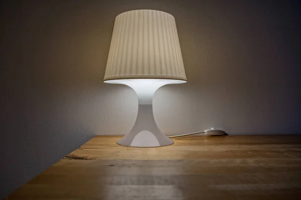 Turn on bedside lamp is on the table
