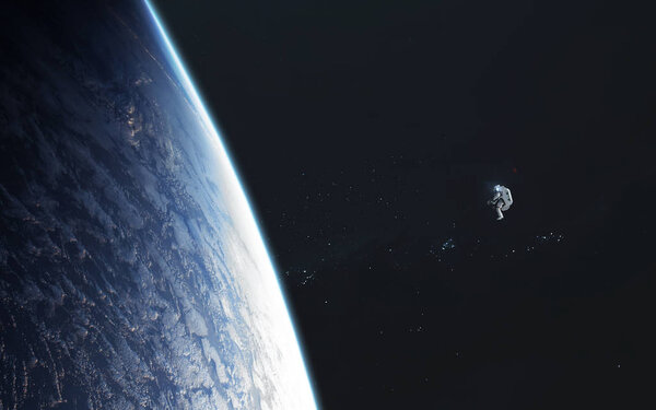 Astronaut looks at the Earth planet from orbit. Elements of this