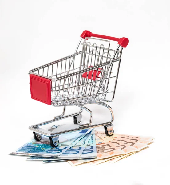 ショッピング カートと分離されたお金 — ストック写真