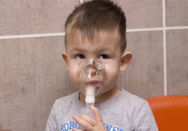 Sevimli çocuk enhalasyon tedavisi astım ilacı maskesi tarafından. Ima kadar kapatın
