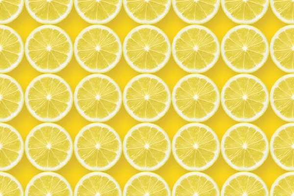 Lemon slices over yellow — Stock Photo, Image