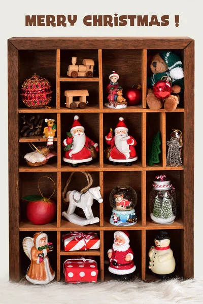Wooden shadow box with christmas decor and toy collection — Stock Photo, Image