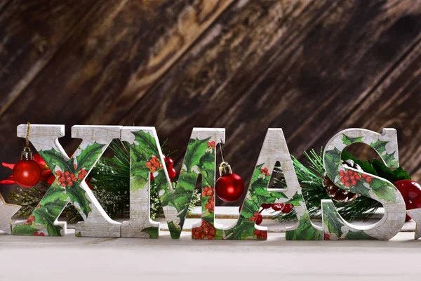 decoupage decorated XMAS letters on wooden background