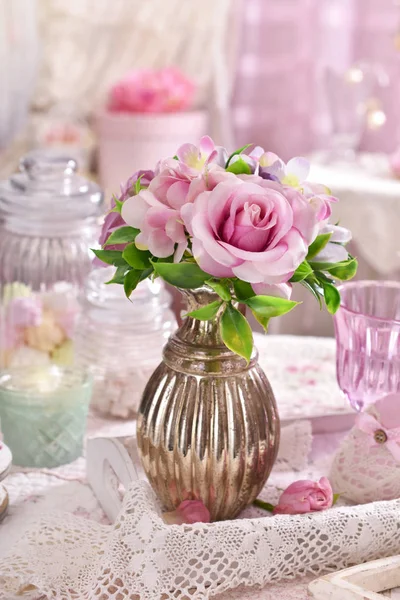 Bunch of pink flowers in vase on the table in shabby chic style Royalty Free Stock Photos