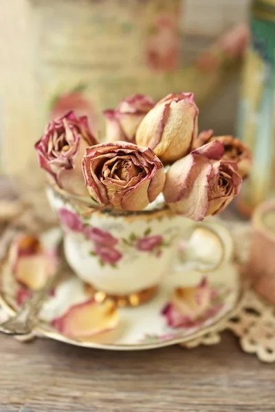 Rosas secas en taza de porcelana de estilo vintage —  Fotos de Stock