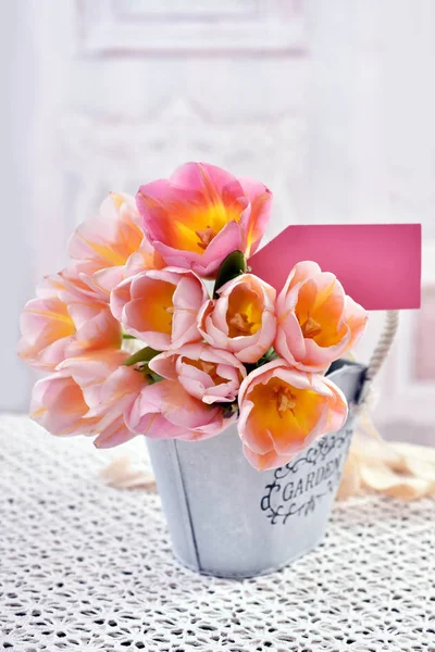 Bunch of tulips in vintage style metal pot — Stock Photo, Image