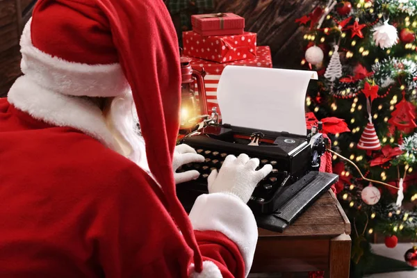 Santa Claus writing a letter on old typewriter — Stock Photo, Image