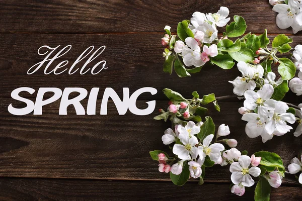 Hello Spring Background Apple Blossom Branches Dark Wooden Table Text — стоковое фото