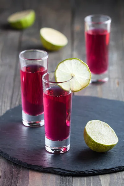 Shots de álcool com vodka, rum, baga e limão — Fotografia de Stock