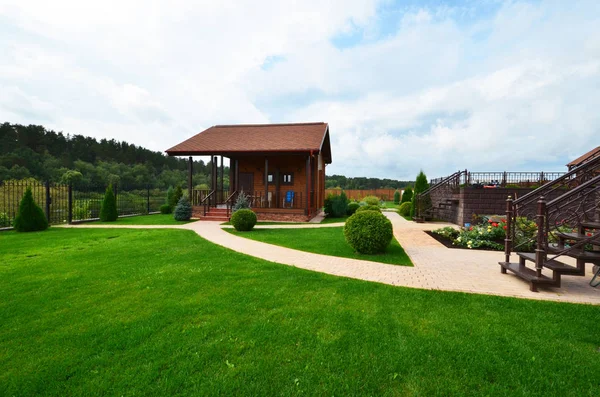 Landscape design on the site of a country house. Russia.A wooden — Stock Photo, Image