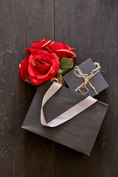 A studio photo of a black gift bag
