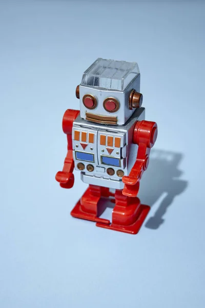 A studio photo of a toy robot