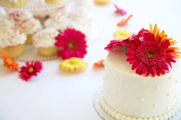 authentic candid photo of a beautiful wedding cake and other pastries on a table before a reception toned with a warm retro vintage instagram filter