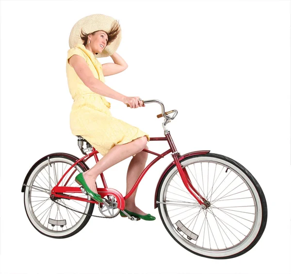 Pretty woman riding a cruiser bike with blowing hair studio shot isolated on a white background with a clipping path — Stock Photo, Image