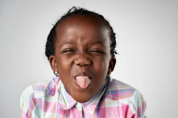 African girl showing tongue — Stock Photo, Image