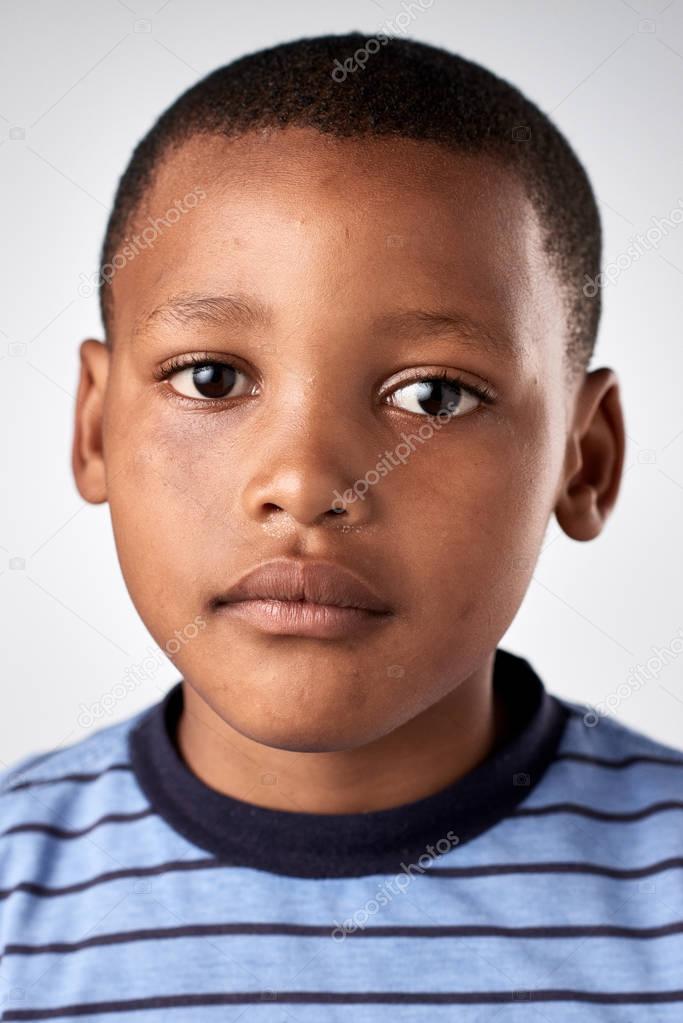 little African boy with no expression